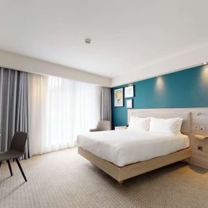 Bright and spacious king suite with working station at the Hampton by Hilton Manchester Northern Quarter.