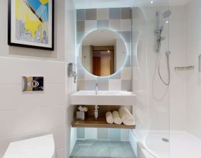 Guest bathroom with shower at the Hampton by Hilton Manchester Northern Quarter.