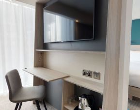 Day use room with living room, TV and work desk at the Hampton by Hilton Manchester Northern Quarter.