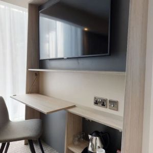 Day use room with living room, TV and work desk at the Hampton by Hilton Manchester Northern Quarter.