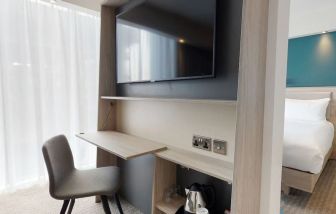 Day use room with living room, TV and work desk at the Hampton by Hilton Manchester Northern Quarter.