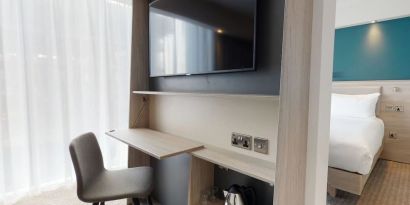 Day use room with living room, TV and work desk at the Hampton by Hilton Manchester Northern Quarter.