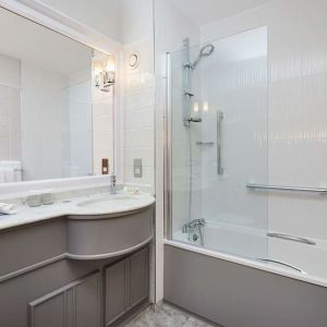 Guest bathroom with shower and tub at DoubleTree By Hilton Coventry.