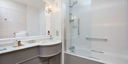 Guest bathroom with shower and tub at DoubleTree By Hilton Coventry.