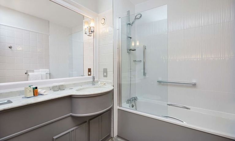 Guest bathroom with shower and tub at DoubleTree By Hilton Coventry.