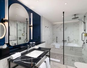 Guest bathroom with shower and tub at Lost Property St. Paul's London, Curio Collection By Hilton.