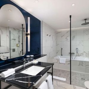 Guest bathroom with shower and tub at Lost Property St. Paul's London, Curio Collection By Hilton.