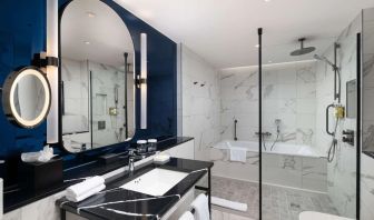 Guest bathroom with shower and tub at Lost Property St. Paul's London, Curio Collection By Hilton.