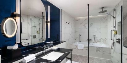 Guest bathroom with shower and tub at Lost Property St. Paul's London, Curio Collection By Hilton.