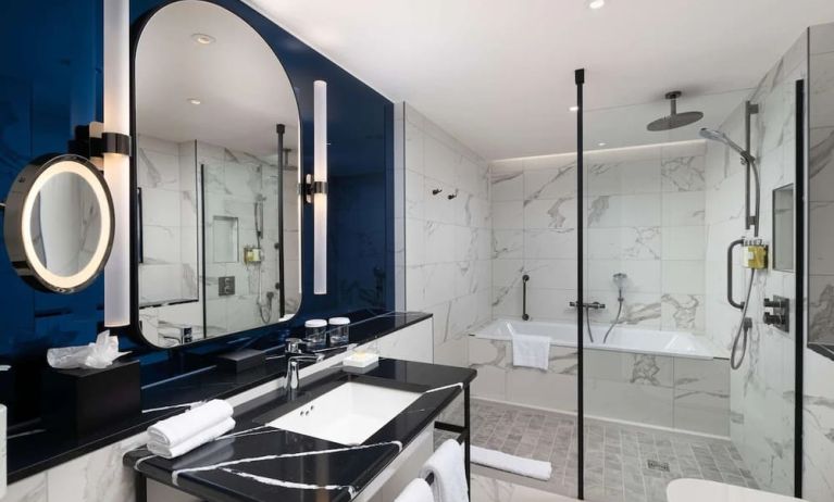 Guest bathroom with shower and tub at Lost Property St. Paul's London, Curio Collection By Hilton.