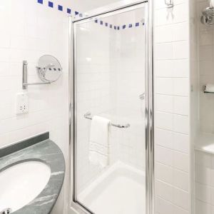 Guest bathroom with shower at Hilton Garden Inn Bristol City Centre.