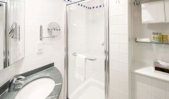 Guest bathroom with shower at Hilton Garden Inn Bristol City Centre.