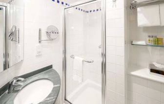 Guest bathroom with shower at Hilton Garden Inn Bristol City Centre.