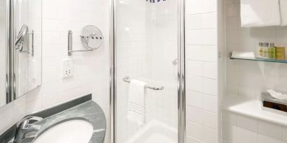 Guest bathroom with shower at Hilton Garden Inn Bristol City Centre.