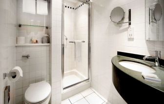 Guest bathroom with shower at Hilton Garden Inn Glasgow City Centre.