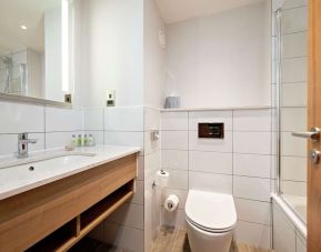 Guest bathroom with shower and tub at Hilton Garden Inn Abingdon Oxford.