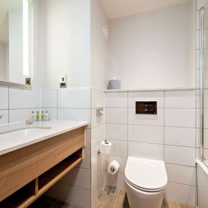 Guest bathroom with shower and tub at Hilton Garden Inn Abingdon Oxford.