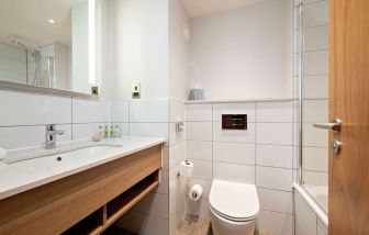 Guest bathroom with shower and tub at Hilton Garden Inn Abingdon Oxford.