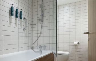 Guest bathroom with shower and tub at Hilton Garden Inn Stoke On Trent.