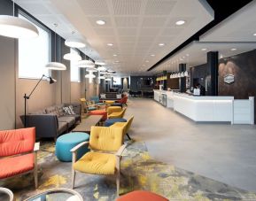 Spacious hotel lobby with lounge area, perfect for co-working at the Hampton by Hilton London Docklands.