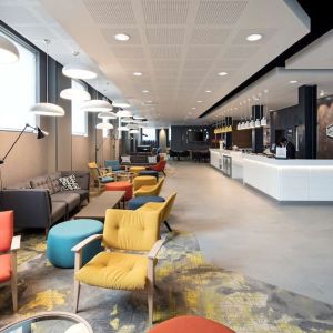 Spacious hotel lobby with lounge area, perfect for co-working at the Hampton by Hilton London Docklands.