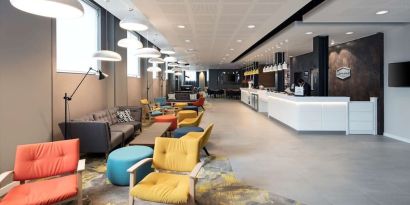 Spacious hotel lobby with lounge area, perfect for co-working at the Hampton by Hilton London Docklands.