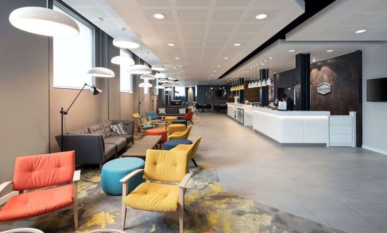 Spacious hotel lobby with lounge area, perfect for co-working at the Hampton by Hilton London Docklands.