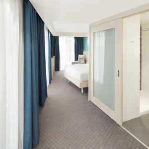 Bright day use room with TV, sofa and private bathroom at the Hampton by Hilton London Docklands.