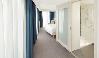 Bright day use room with TV, sofa and private bathroom at the Hampton by Hilton London Docklands.