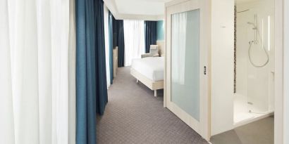 Bright day use room with TV, sofa and private bathroom at the Hampton by Hilton London Docklands.