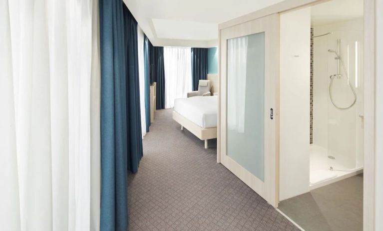 Bright day use room with TV, sofa and private bathroom at the Hampton by Hilton London Docklands.