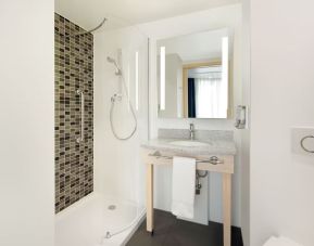 Guest bathroom at the Hampton by Hilton London Docklands.