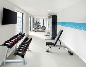 Bright fitness center with machines and equipment at the Hampton by Hilton London Docklands.