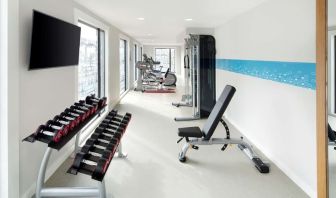 Bright fitness center with machines and equipment at the Hampton by Hilton London Docklands.