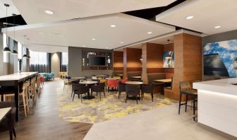 Lobby workspace with tables and chairs at the Hampton by Hilton London Docklands.