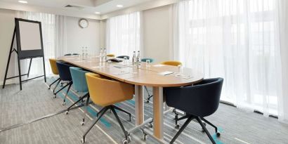 Bright meeting room with blackboard and comfortable mobiliary at the Hampton by Hilton London Docklands.