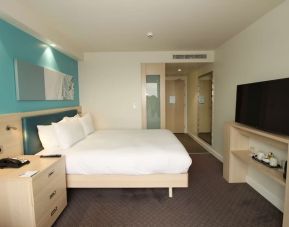 Day use room with TV and workdesk at the Hampton by Hilton London Docklands.