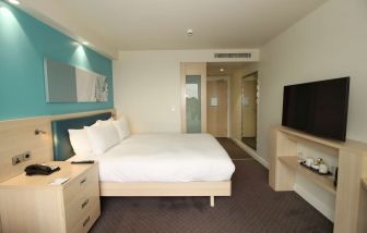 Day use room with TV and workdesk at the Hampton by Hilton London Docklands.