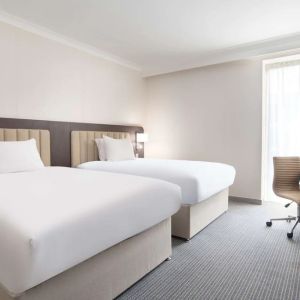 Double guest room with TV screen and desk at the Hilton London Gatwick Airport.