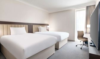 Double guest room with TV screen and desk at the Hilton London Gatwick Airport.