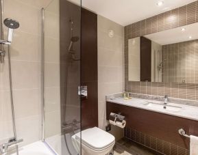 Guest bathroom with shower and free toiletries at the Hilton London Gatwick Airport.