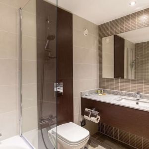 Guest bathroom with shower and free toiletries at the Hilton London Gatwick Airport.