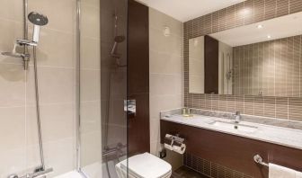 Guest bathroom with shower and free toiletries at the Hilton London Gatwick Airport.