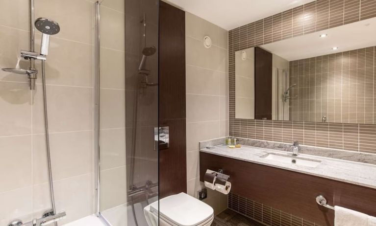 Guest bathroom with shower and free toiletries at the Hilton London Gatwick Airport.