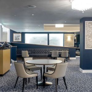 Hotel restaurant with comfortable chairs, perfect for co-working at the Hilton London Gatwick Airport.