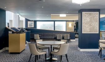 Hotel restaurant with comfortable chairs, perfect for co-working at the Hilton London Gatwick Airport.