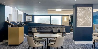 Hotel restaurant with comfortable chairs, perfect for co-working at the Hilton London Gatwick Airport.