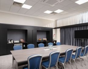 Elegant meeting room with TV for presentations at the Hilton London Gatwick Airport.