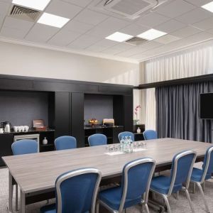 Elegant meeting room with TV for presentations at the Hilton London Gatwick Airport.