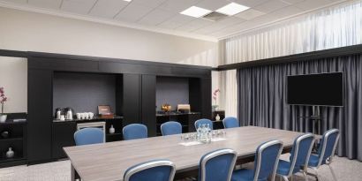 Elegant meeting room with TV for presentations at the Hilton London Gatwick Airport.